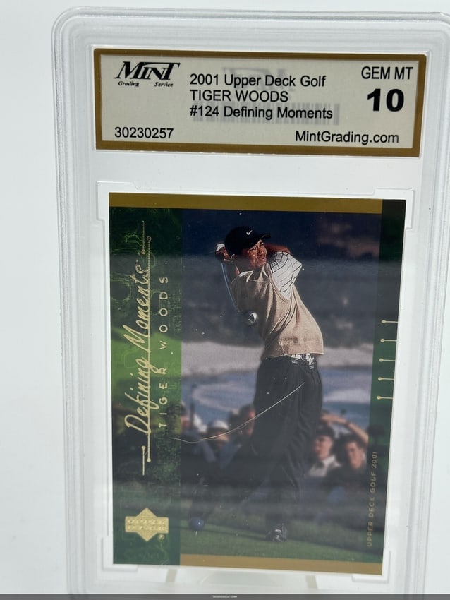 2001 Upper Deck Tiger Woods Golf Card #124: A 2001 upper deck golf trading card featuring tiger woods, numbered #124 from the 'defining moments' series. The card is graded 'gem mint 10' by mint grading service, showcasing its pristine