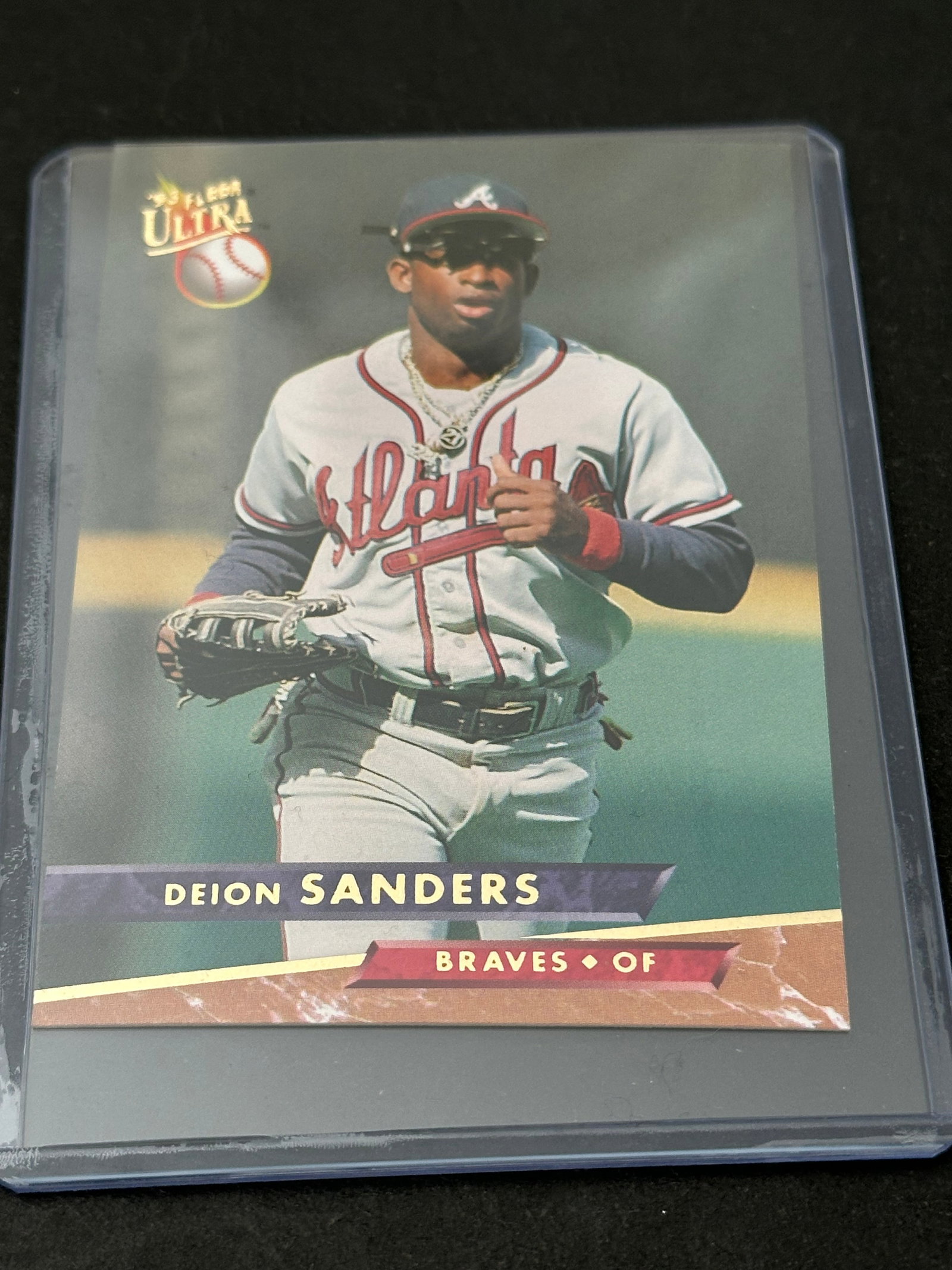 1993 Fleer Baseball Card Featuring Deion Sanders: 1993 fleer baseball card featuring deion sanders of the atlanta braves. Classic 1990s baseball card release. The card displays his player statistics, biographical information, and a smaller action