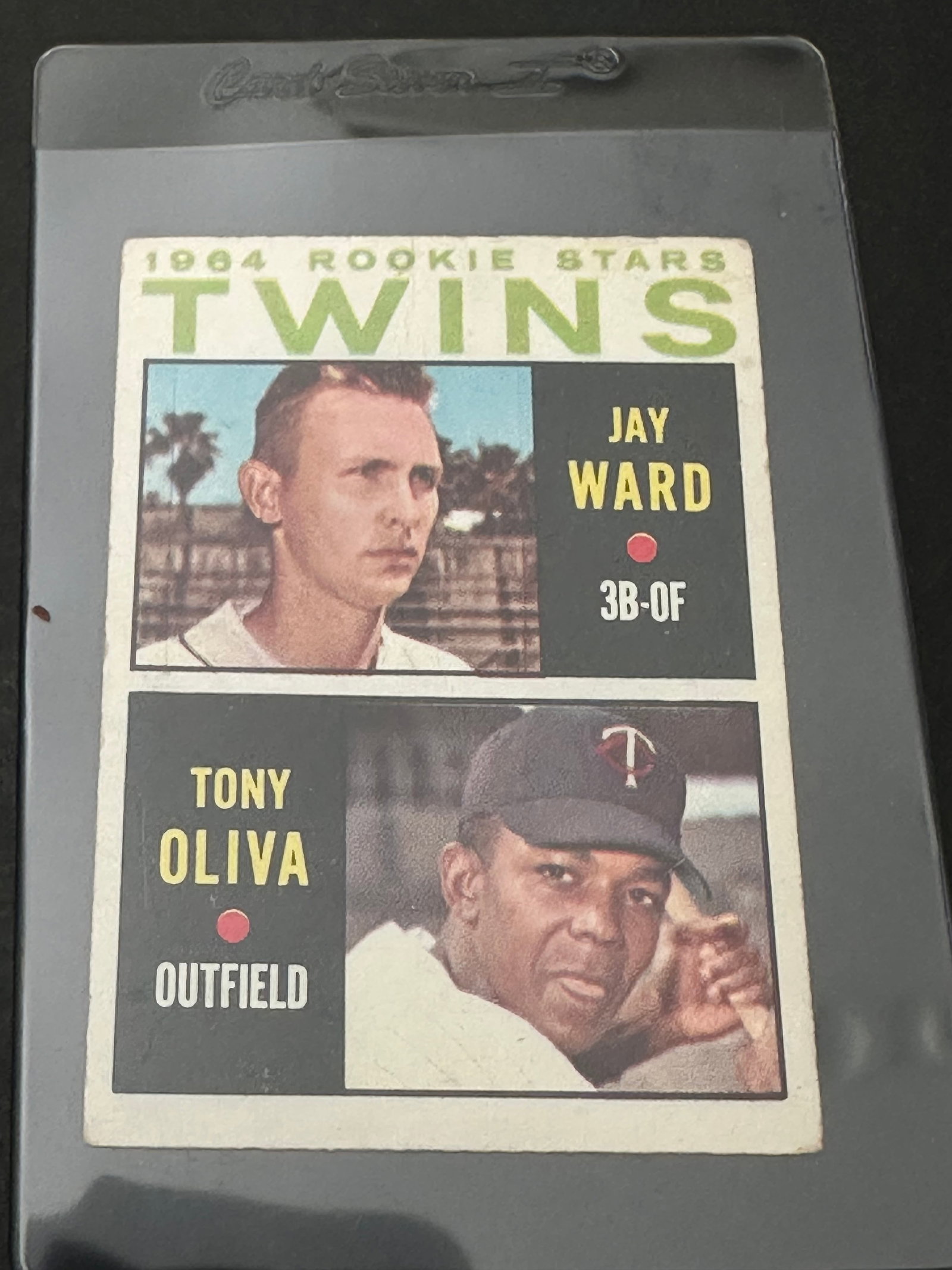 1964 Topps Baseball Card Featuring Minnesota Twins Players Jay Ward And Tony Oliva: A 1964 topps baseball card featuring the twins' rookie stars, jay ward and tony oliva. The card is encased in a protective plastic sleeve. It displays player biographical information and minor league 