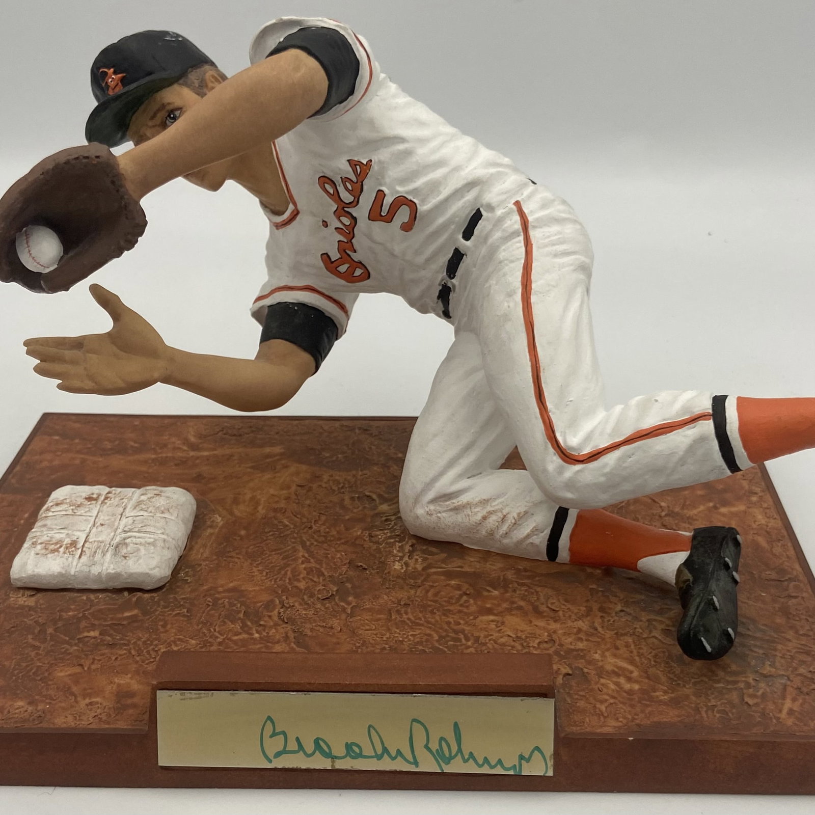 Brooks Robinson Baltimore Orioles Figurine: a detailed sports figurine featuring Hall of Famer Brooks Robinson of the Baltimore Orioles. It depicts him in a defensive diving position on a baseball base, complete with a nameplate on the display