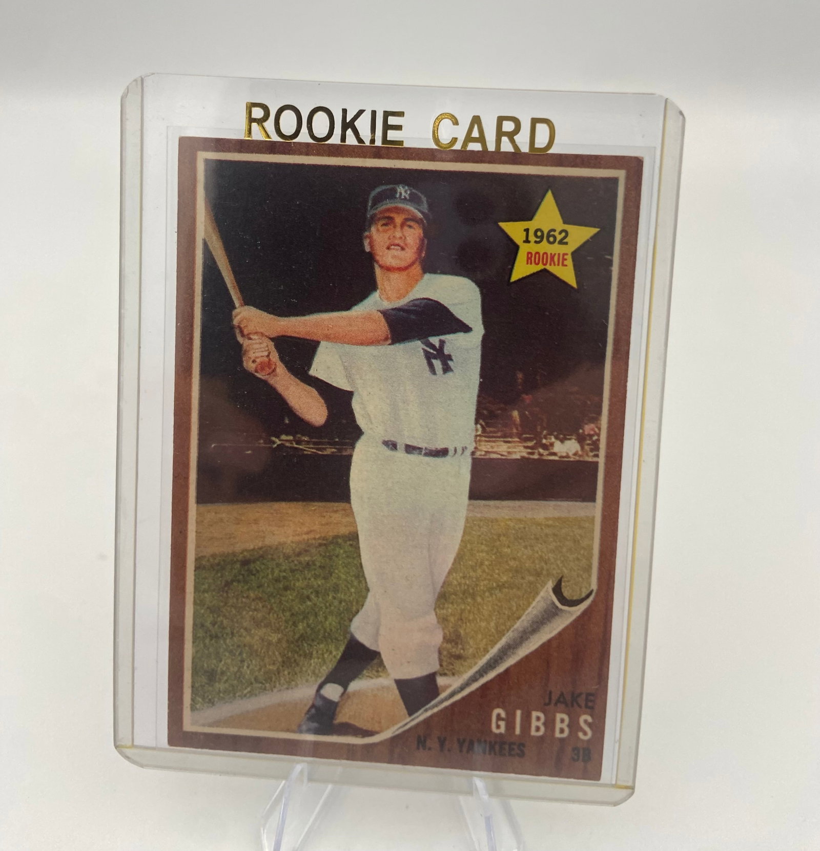 1962 Topps Jake Gibbs Rookie Card: This is a 1962 Topps baseball card featuring New York Yankees player Jake Gibbs. It is identified as a rookie card for the player and is housed in a clear protective plastic sleeve.