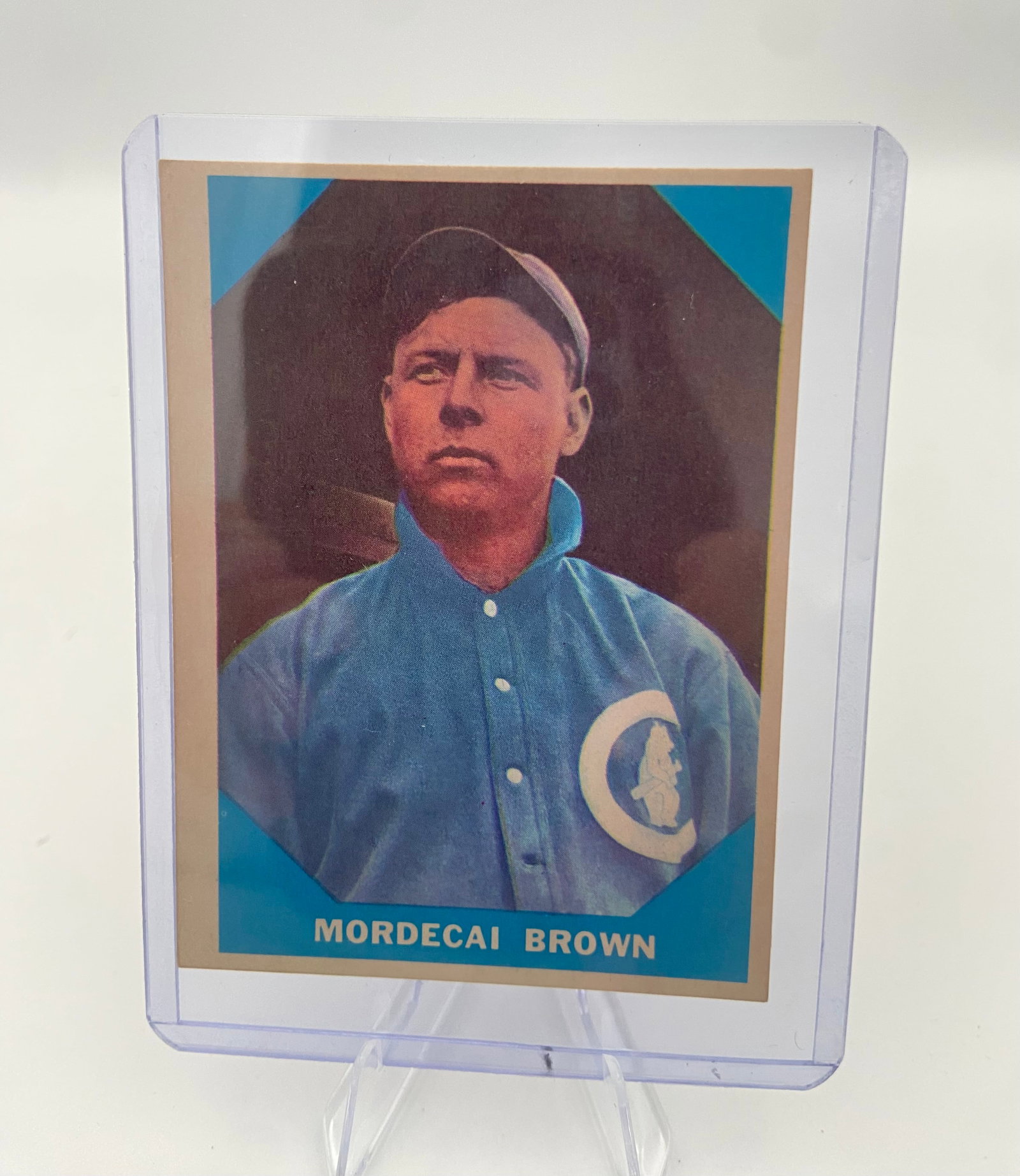 Mordecai Brown 1951 Topps Red Back Baseball Card: This is a 1951 Topps Red Back baseball card featuring Chicago Cubs pitcher Mordecai Brown. The card shows a vibrant portrait of the Hall of Fame player in his blue uniform within a blue background.