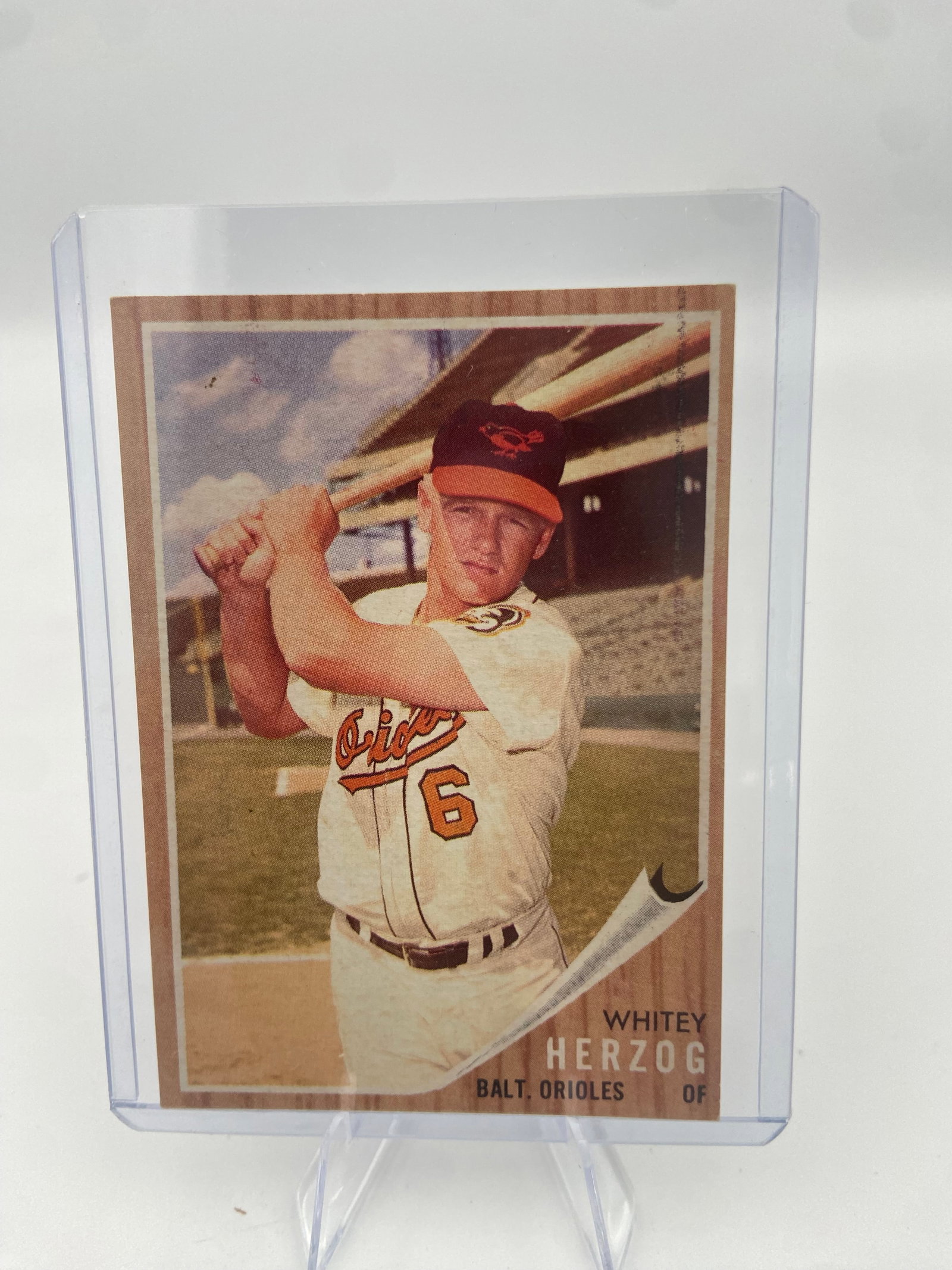 1960 Topps Whitey Herzog Baseball Card: This is a 1960 Topps baseball card featuring Whitey Herzog of the Baltimore Orioles. The card is protected in a clear rigid plastic top loader.