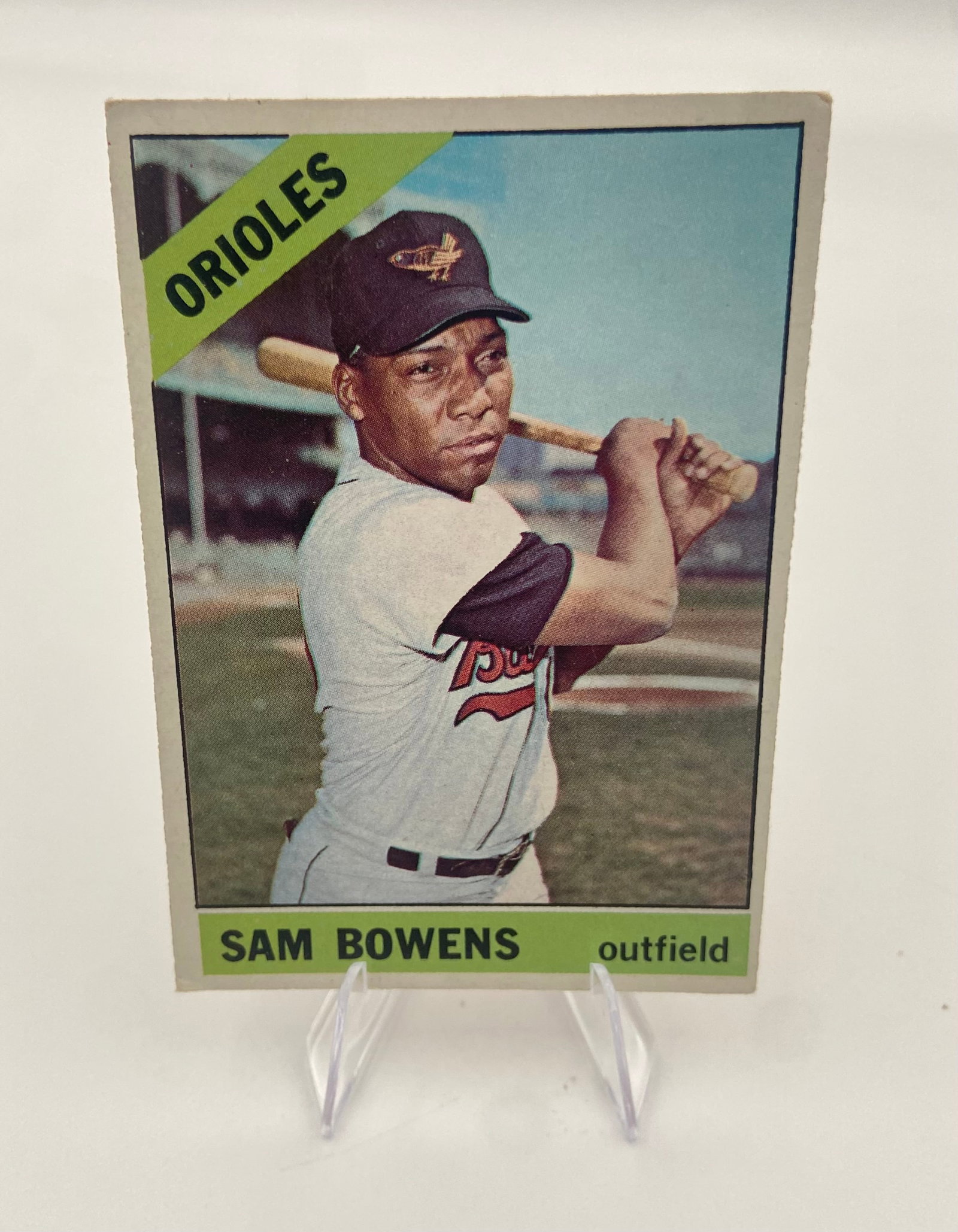 1966 Topps Sam Bowens Baltimore Orioles Baseball Card: This is a 1966 Topps baseball card featuring Baltimore Orioles outfielder Sam Bowens. The card shows Bowens in his uniform holding a bat, with the team name displayed in a signature green diagonal