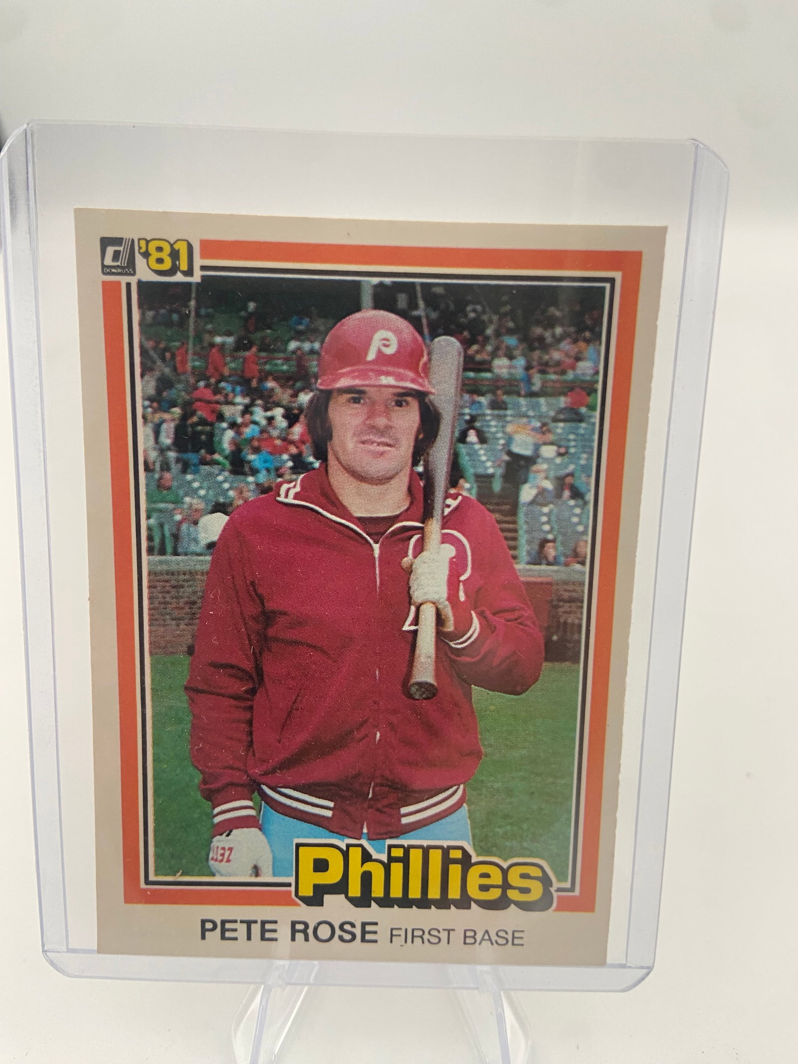 1981 Donruss Pete Rose Philadelphia Phillies Card: This is a 1981 Donruss baseball card featuring Pete Rose of the Philadelphia Phillies. The card is encased in a protective top loader for preservation. It is a notable vintage card from the first
