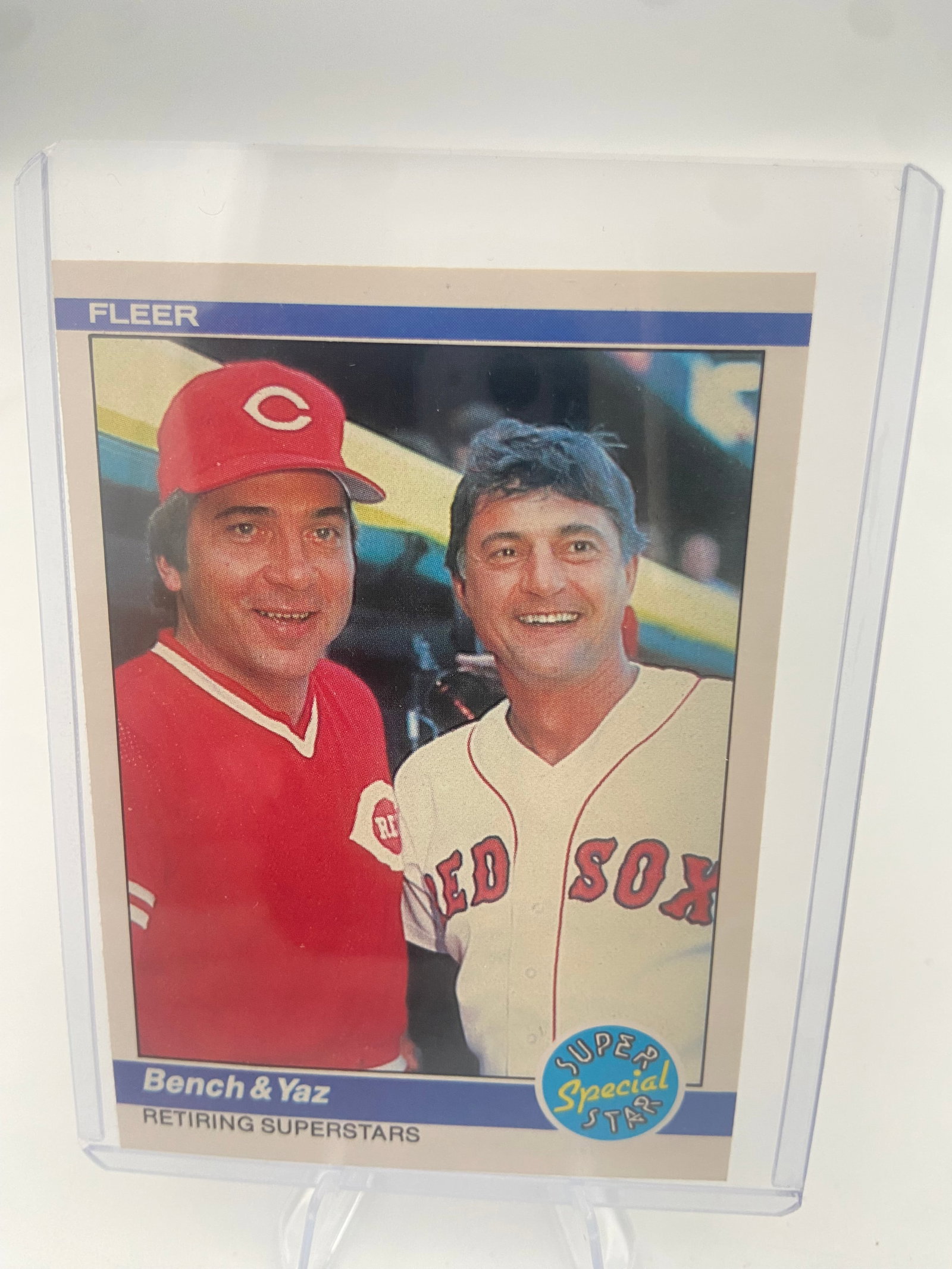 1984 Fleer Bench & Yaz Retiring Superstars Card: This is a 1984 Fleer 'Retiring Superstars' baseball card featuring Johnny Bench and Carl Yastrzemski. The card is encased in a protective plastic top loader. It highlights two legendary players who