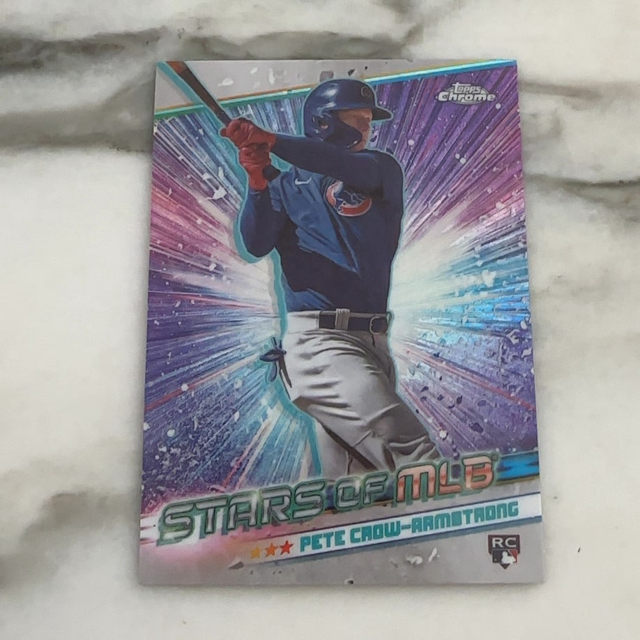 Pete Crow-Armstrong Rookie Card: This is a 2024 Topps Chrome Stars of MLB trading card featuring Pete Crow-Armstrong of the Chicago Cubs. The card features a vibrant, radial light background effect and includes the official RC