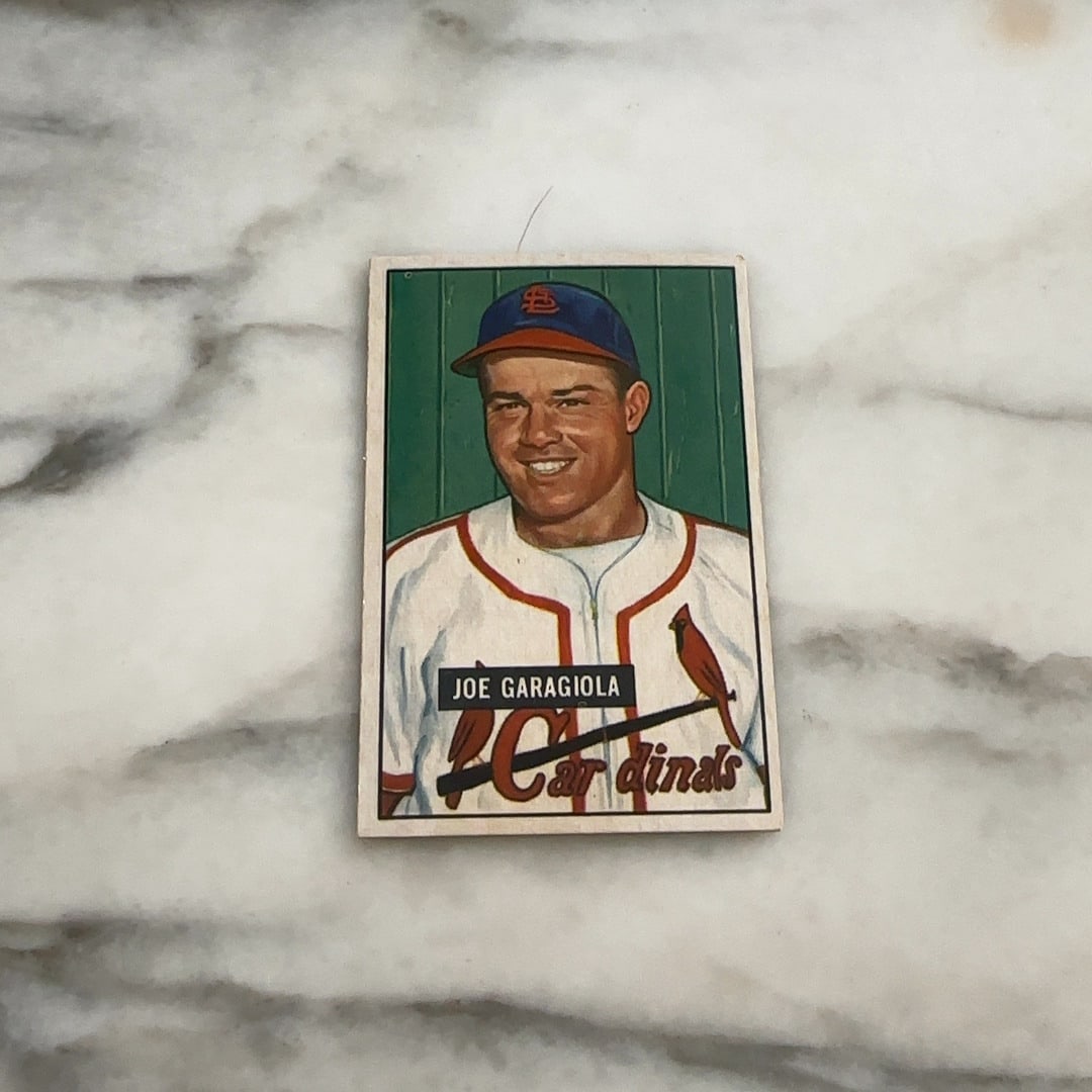 1951 Bowman Joe Garagiola: Joe Garagiola of the St. Louis Cardinals. The front of the card features a color illustration of the player wearing his Cardinals uniform against a green backdrop.