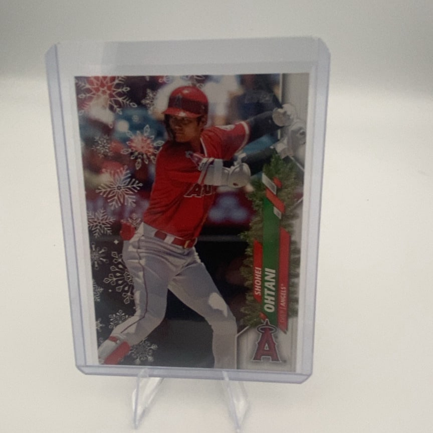 2021 Topps Holiday Shohei Ohtani Baseball Card: 021 Topps Holiday edition baseball card featuring Shohei Ohtani of the Los Angeles Angels. The card features a special holiday-themed winter snowflake design