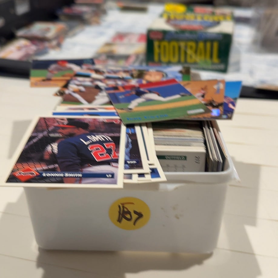 Open Case of MLB Cards - Sports Trading Cards: This is a stack of assorted 1990s baseball trading cards held in a plastic container. The top visible card is a 1993 Donruss card featuring Lonnie Smith of the Atlanta Braves, while a Tony Gwynn Stadi