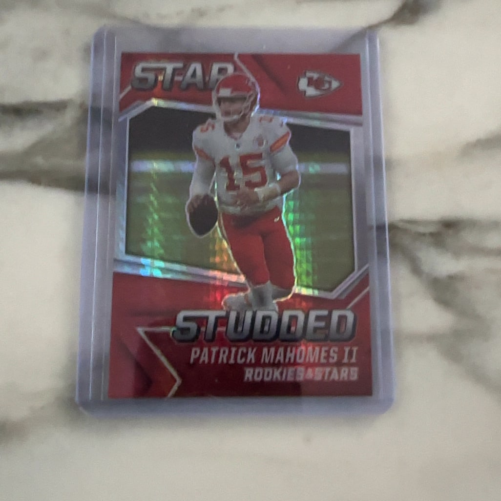 Patrick Mahomes II Star Studded: This is a sports trading card featuring Kansas City Chiefs quarterback Patrick Mahomes II. The card is part of the 'Star Studded' insert set from the Rookies & Stars brand. The design features a red c