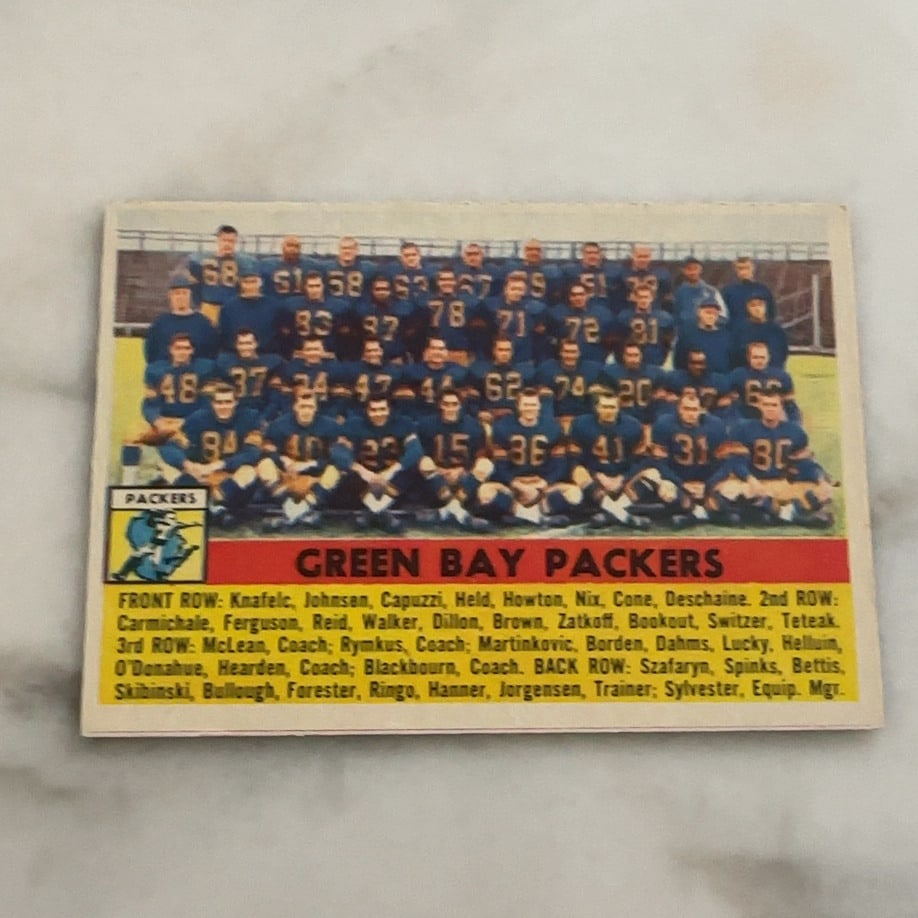 Green Bay Packers Team Card: This is a vintage trading card featuring a team photo of the Green Bay Packers. The card identifies the players and staff listed in rows beneath the team photo.