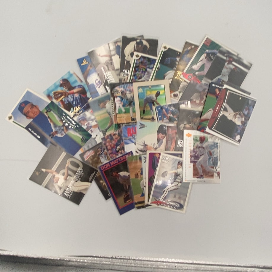 Assorted MLB Baseball Card Lot: A collection of various vintage MLB baseball cards featuring players such as John Smoltz, Don Mattingly, Andruw Jones, and Edgar Martinez. The lot includes cards from manufacturers like Upper Deck,