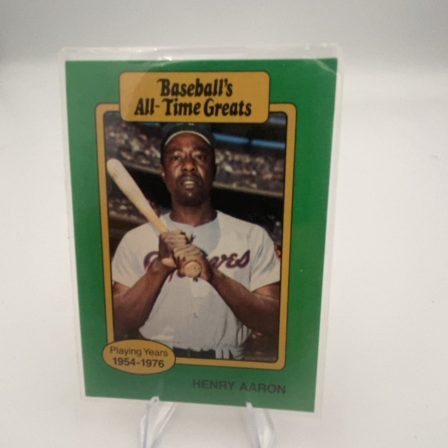 Henry Aaron Baseball's All-Time Greats: collectible trading card featuring Henry Aaron from the 1987 Hygrade Baseball's All-Time Greats set. The card features a green border, the text 'Baseball's All-Time Greats' at the top, and 'Playing