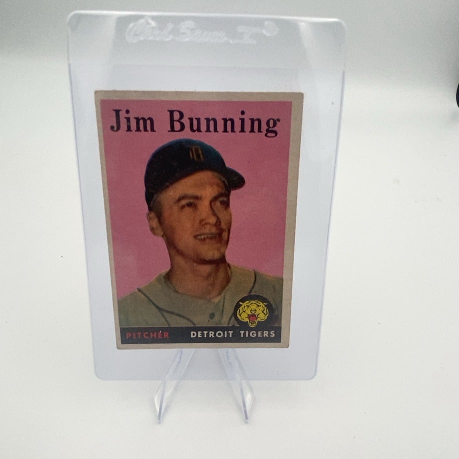 Jim Bunning: a vintage baseball card featuring Jim Bunning of the Detroit Tigers. The card displays a portrait of the pitcher with a pink background and a team logo.Raw - ungraded - condition is as shown and sold 