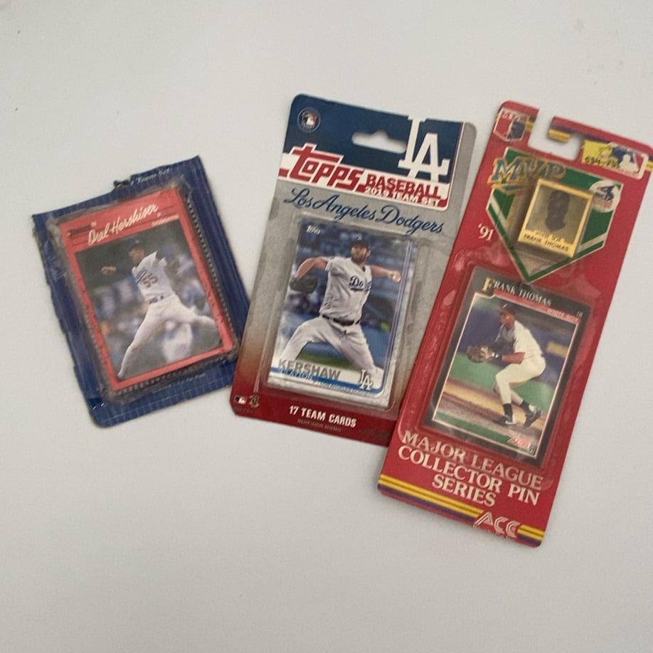 Baseball Memorabilia Lot: lot features three distinct pieces of baseball memorabilia including a packaged Orel Hershiser card, a 2019 Topps Los Angeles Dodgers team set featuring Clayton Kershaw, and a 1991 Major League