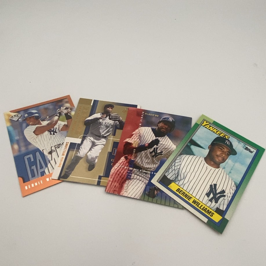 Bernie Williams Baseball Card Collection: lot features four different baseball trading cards of New York Yankees outfielder Bernie Williams. The collection includes his 1990 Topps rookie card, along with 1995 Fleer, 1995 Leaf, and 1995 Ultra 