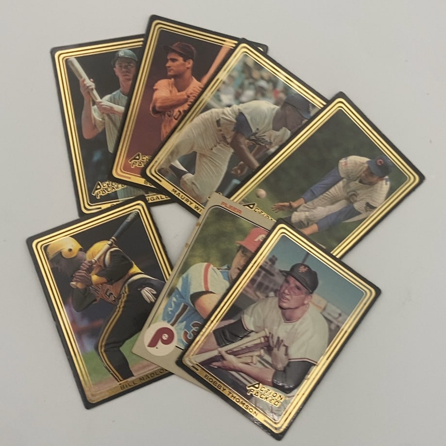 Action Packed Baseball Cards Assortment: collection of assorted baseball trading cards featuring various players. The cards are primarily marked with Action Packed branding and include specific player names like Maury Wills, Bill Madlock,