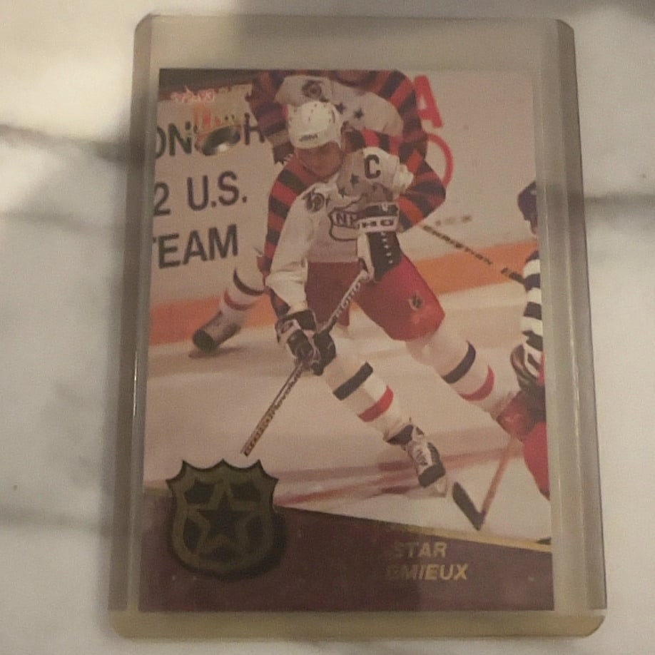 1992-93 O-Pee-Chee Mario Lemieux Star Card: This is a 1992-93 O-Pee-Chee hockey trading card featuring Mario Lemieux in his Team Canada jersey. The card is enclosed in a protective plastic top loader and showcases the iconic 'Star' subset