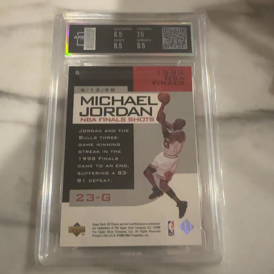 1998 Michael Jordan UD Choice NBA Finals Shots Card: This is a 1998 Upper Deck Choice 'NBA Finals Shots' trading card featuring Michael Jordan. The card is professionally encapsulated and graded by ARENA Club, showcasing a high surface grade. It commemo