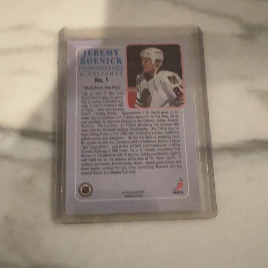 1992 Pro Set Jeremy Roenick Performance Highlights Card: This is a 1992 Pro Set 'Performance Highlights' trading card featuring NHL star Jeremy Roenick of the Chicago Blackhawks. The card is encased in a protective plastic sleeve and highlights the player's