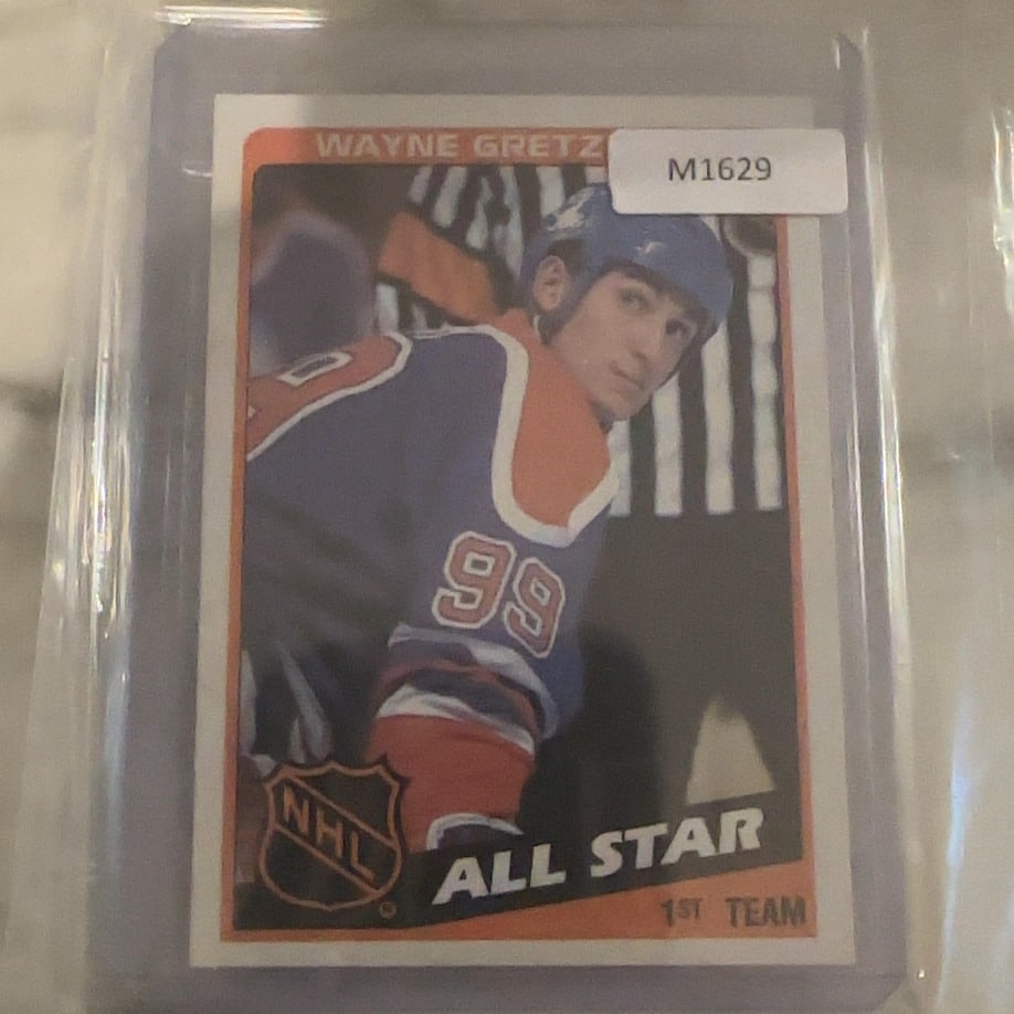 Wayne Gretzky 1980 O-Pee-Chee All-Star Hockey Card: This is a vintage 1980 O-Pee-Chee hockey trading card featuring Wayne Gretzky of the Edmonton Oilers in his 1st Team All-Star attire. The card is encased in a protective plastic sleeve and displays ic