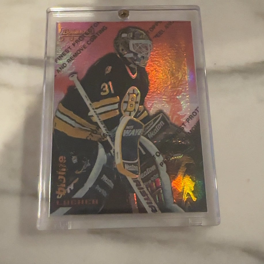 Byron Dafoe Bowman's Best Atomic Refractor: This is a 1997 Bowman's Best hockey card featuring Boston Bruins goaltender Byron Dafoe. The card is a highly sought-after Atomic Refractor parallel, recognizable by its unique shimmering holographic