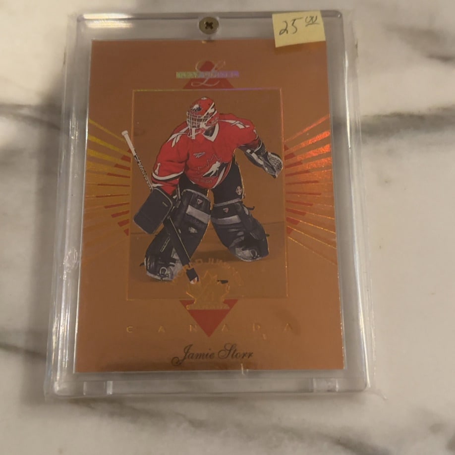 Jamie Storr 1998-99 Private Stock Gold Hockey Card: This is a 1998-99 Private Stock hockey trading card featuring goaltender Jamie Storr in his Team Canada jersey. The card features a distinctive gold foil design from the high-end release produced by