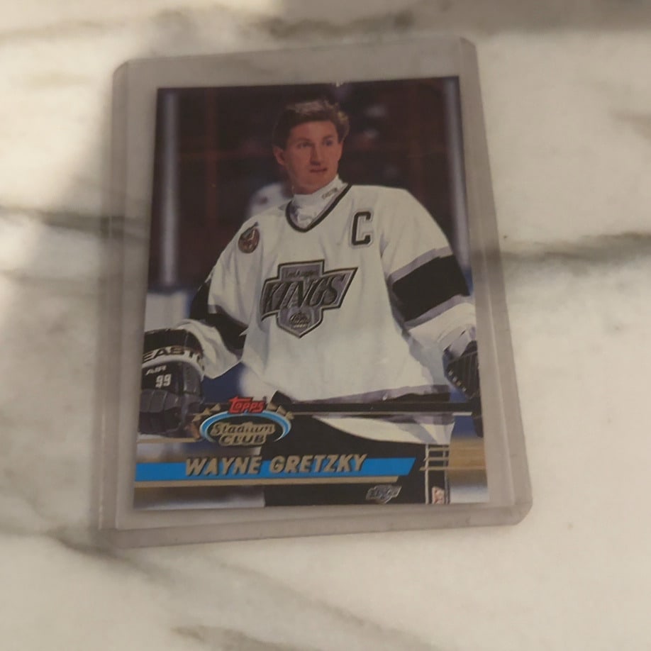 1992 Topps Stadium Club Wayne Gretzky: This is a 1992 Topps Stadium Club hockey card featuring legendary player Wayne Gretzky in his Los Angeles Kings uniform. The card is encased in a protective hard plastic holder.