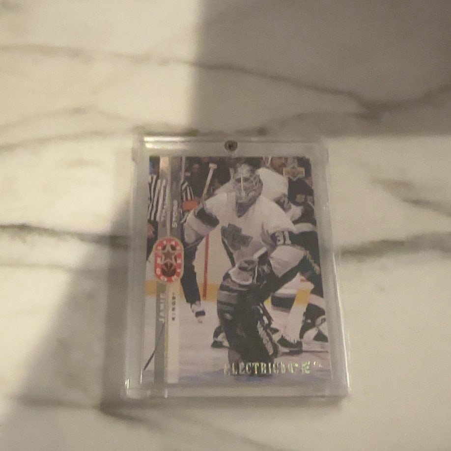 Jamie Storr 1996-97 Upper Deck Electric Ice Card: This is a 1996-97 Upper Deck Electric Ice trading card featuring goaltender Jamie Storr of the Los Angeles Kings. The card captures the player in his team uniform and is presented in a protective