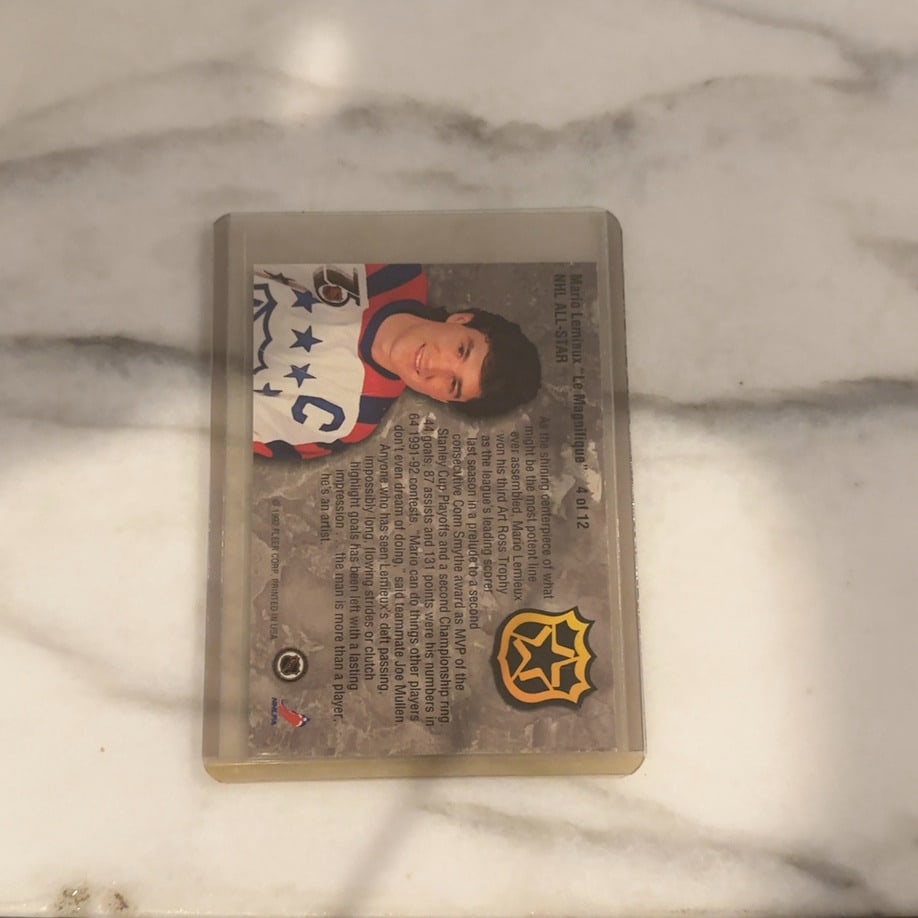 Mario Lemieux 1992 Fleer Ultra All-Star Hockey Card: This is a 1992 Fleer Ultra 'Le Magnifique' hockey card featuring NHL legend Mario Lemieux. The card is part of an All-Star series and serves as a classic piece of 1990s hockey memorabilia.