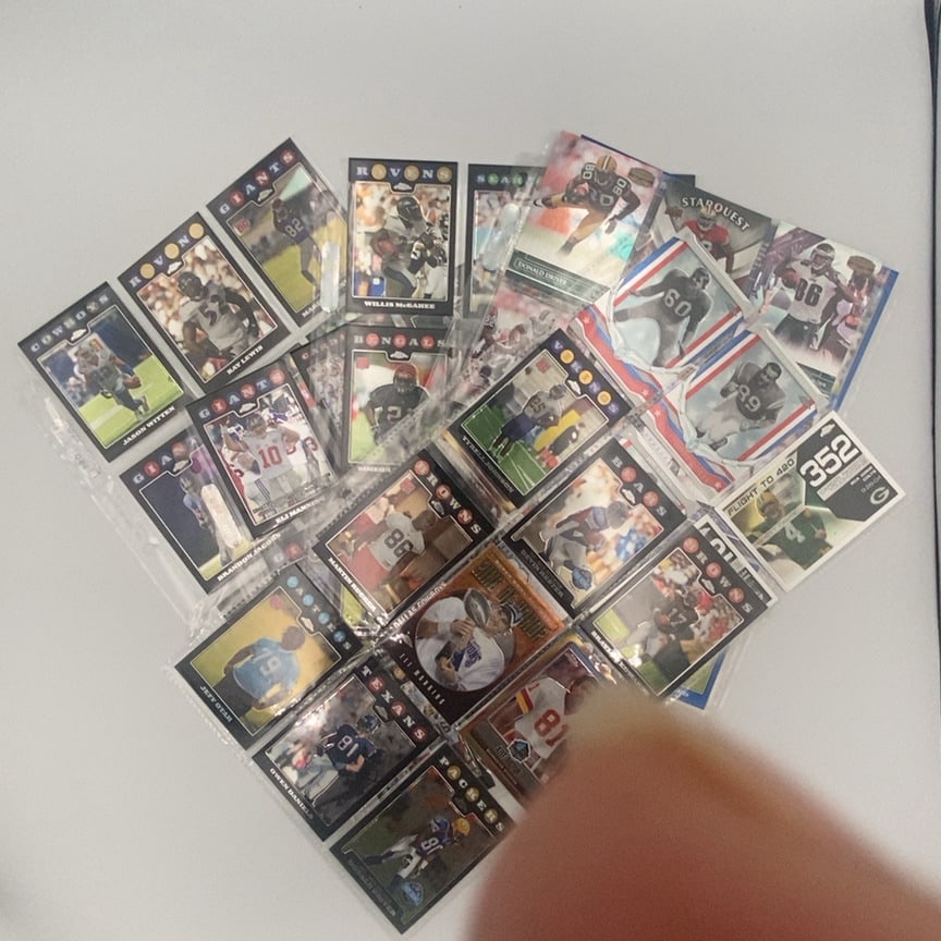 2008 Topps Chrome NFL Trading Card Collectionl: a collection of assorted 2008 Topps Chrome NFL football trading cards, featuring players such as Eli Manning, Jason Witten, and Ray Lewis. These cards are displayed in plastic protective sleeves and s