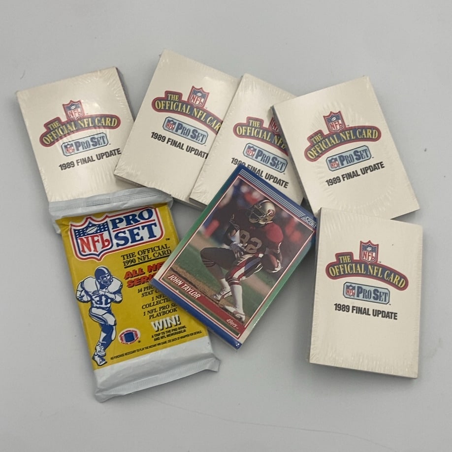 NFL trading cards: A collection of NFL trading card products, including five sealed 1989 Pro Set Final Update sets, a 1990 Pro Set wax pack, and a 1990 Score John Taylor card (#9) for the San Francisco 49ers. The items