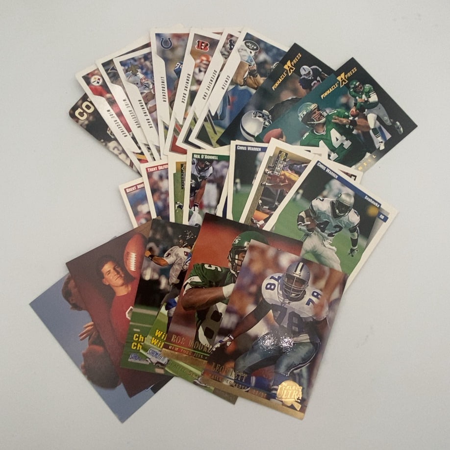 Assorted 1990s NFL Football Cards Lot: A collection of various NFL football trading cards from the 1990s. The lot includes cards from brands such as Pinnacle X-Press, Fleer Ultra, Stadium Club, Collector's Choice, and Pro Set, featuring