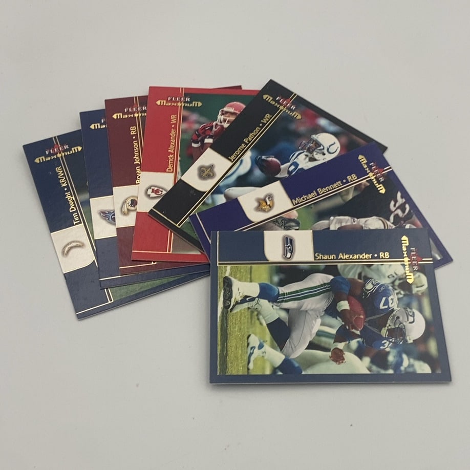 2002 Fleer Maximum Football Trading Cards Lot: A collection of assorted 2002 Fleer Maximum football trading cards featuring various NFL players such as Shaun Alexander, Michael Bennett, and Jerome Pathon. The cards feature action photography, team