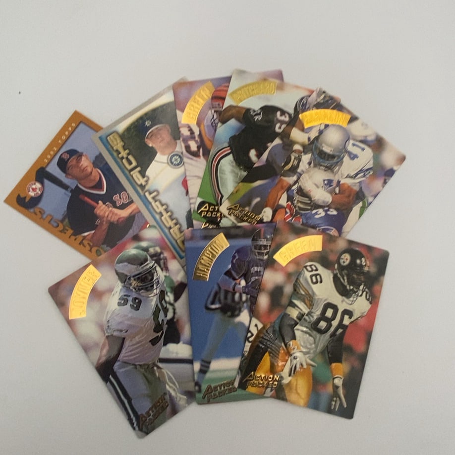 Football Trading Cards: A collection of trading cards featuring several 1990 Action Packed football cards and one 2002 Topps Prospects baseball card. The football cards include players Seth Joyner (Eagles), Rodney Hampton (G