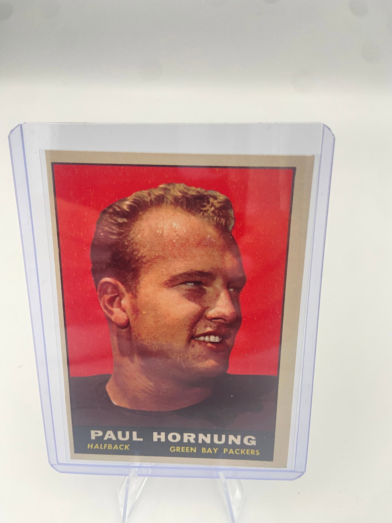1960 Topps Paul Hornung Football Card: This is a 1960 Topps football card featuring Green Bay Packers Hall of Fame halfback, Paul Hornung. The card is protected in a clear rigid plastic top loader.