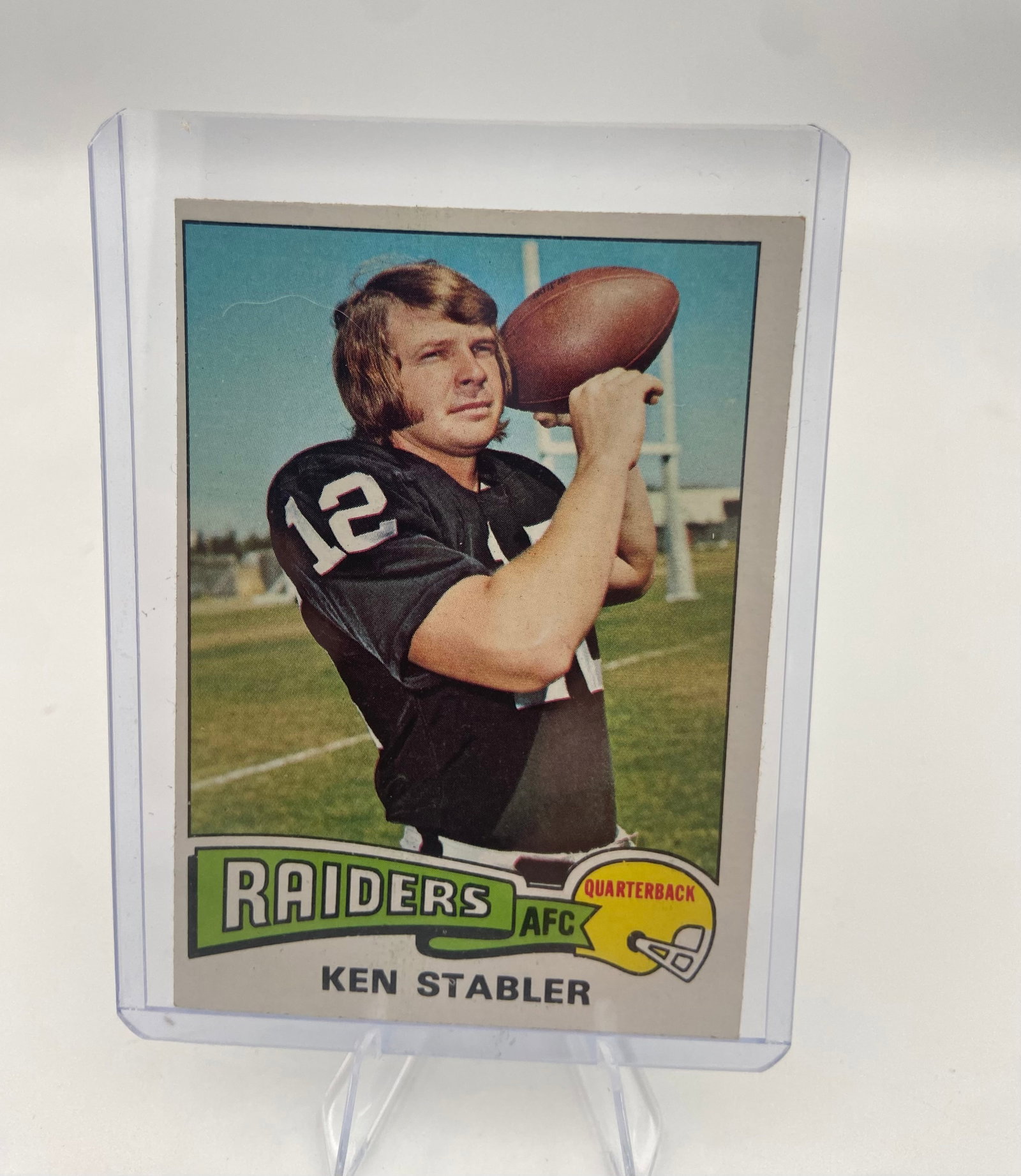 1974 Topps Ken Stabler Raiders Football Card: This is a 1974 Topps football card featuring legendary Oakland Raiders quarterback Ken Stabler. The card features a classic vintage portrait design with team and player identification at the bottom.