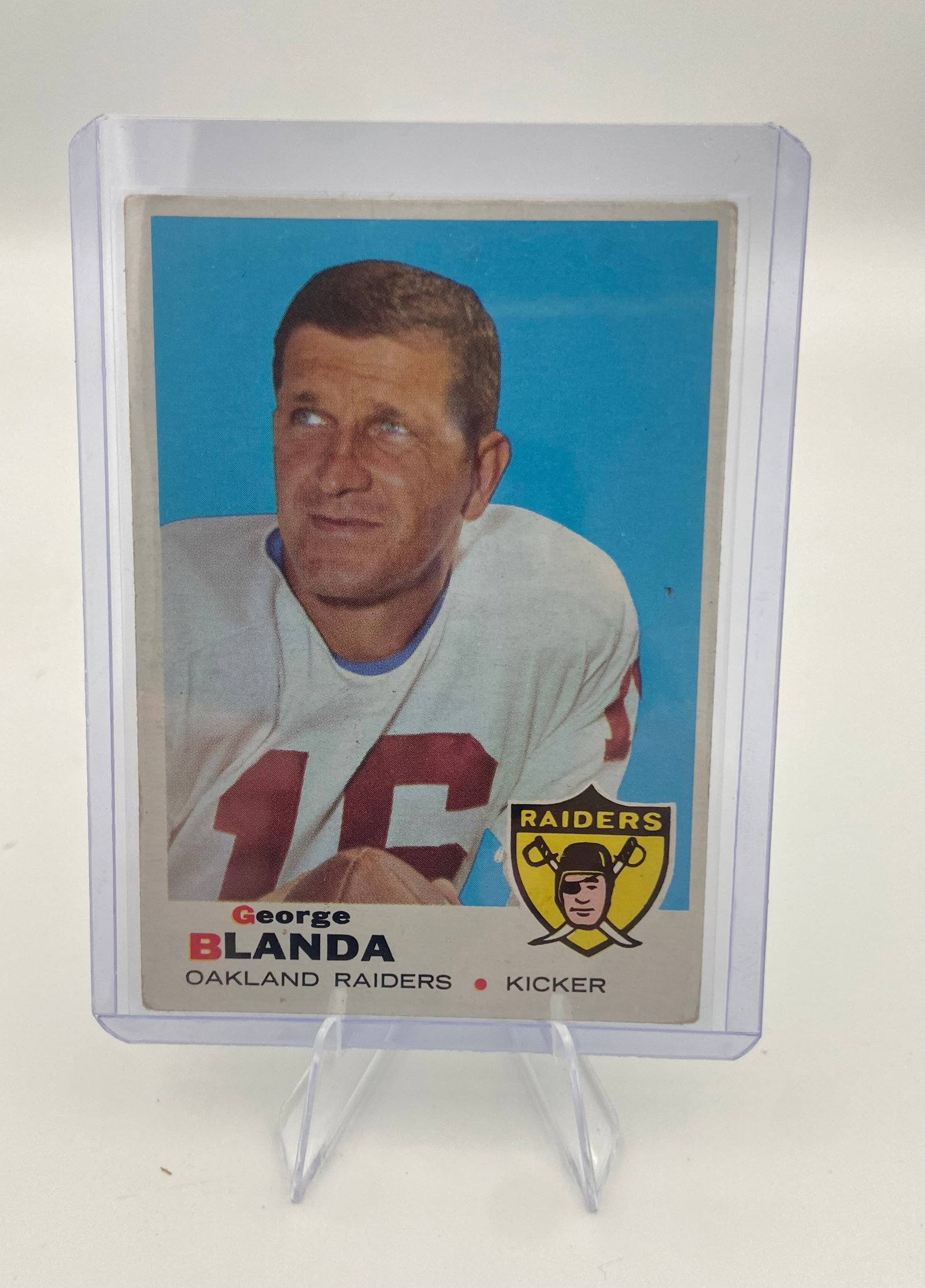 1972 Topps George Blanda #250: This is a 1972 Topps football card featuring George Blanda of the Oakland Raiders. The card depicts the legendary kicker in his team uniform and is protected in a clear plastic card holder.