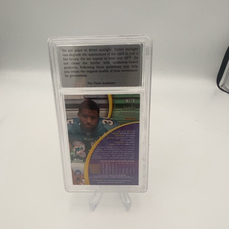 1999 Topps James Johnson #132 Graded Trading Card: This is a 1999 Topps NFL football trading card featuring James Johnson of the Miami Dolphins. The card is professionally graded and encapsulated in a plastic slab by The Final Authority. It displays p