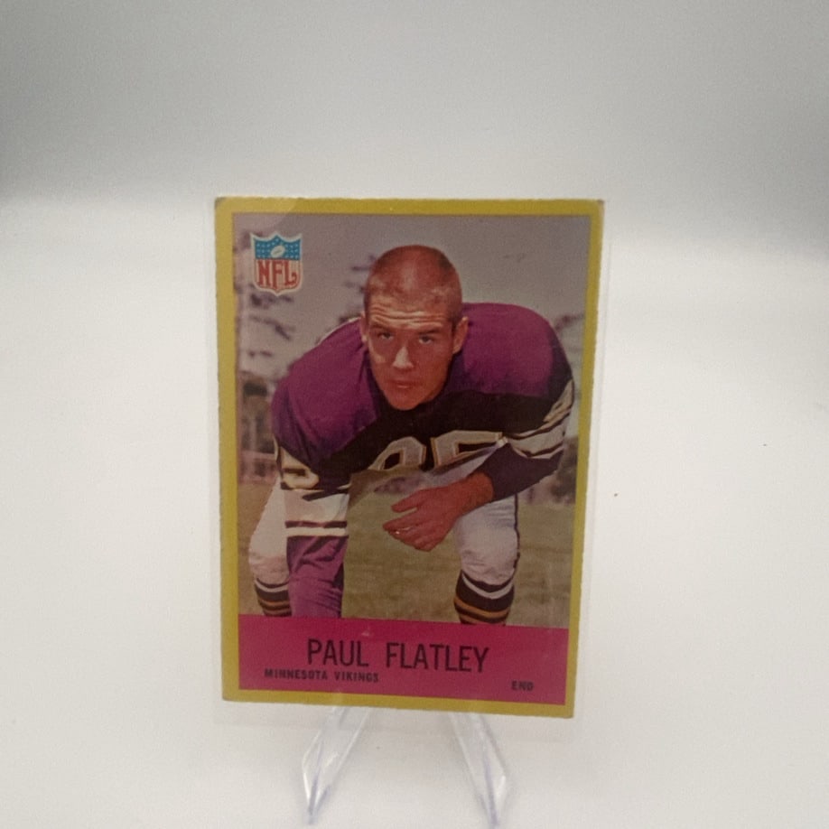 1965 Philadelphia Paul Flatley Football Card: This is a 1965 Philadelphia football card featuring wide receiver Paul Flatley of the Minnesota Vikings. The card features a classic vintage design with a photo of the player in a three-point stance.