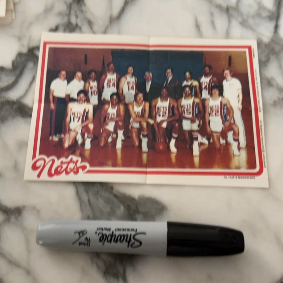 1975-76 New York Nets Team Photo Card: a vintage 1975-76 New York Nets team promotional card featuring the ABA championship team, including Julius Erving. The item is a fold-out style card displaying a full team roster photograph. It