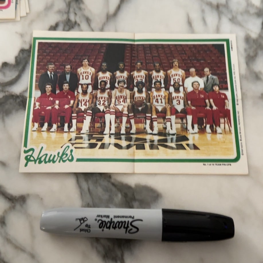 1989 Topps Atlanta Hawks Team Pin-Up: riginal 1989 Topps NBA team pin-up poster featuring the Atlanta Hawks squad. The item displays a full team photograph and is part of a larger series of collectibles issued by Topps. It remains in its