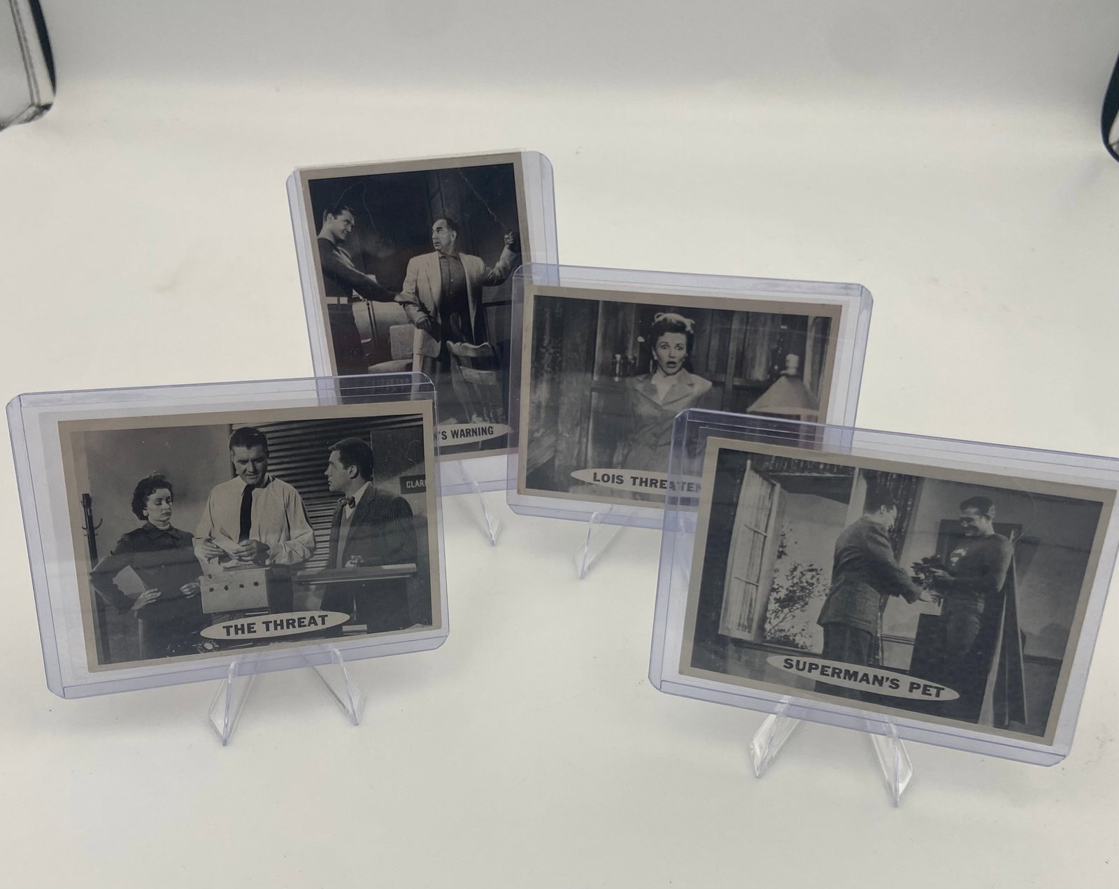 1954 Superman TV Series Trading Cards: collection of four vintage trading cards featuring black and white scenes from the 1950s Superman television series. These cards include titles like 'The Threat', 'Lois Threatened', and 'Superman's