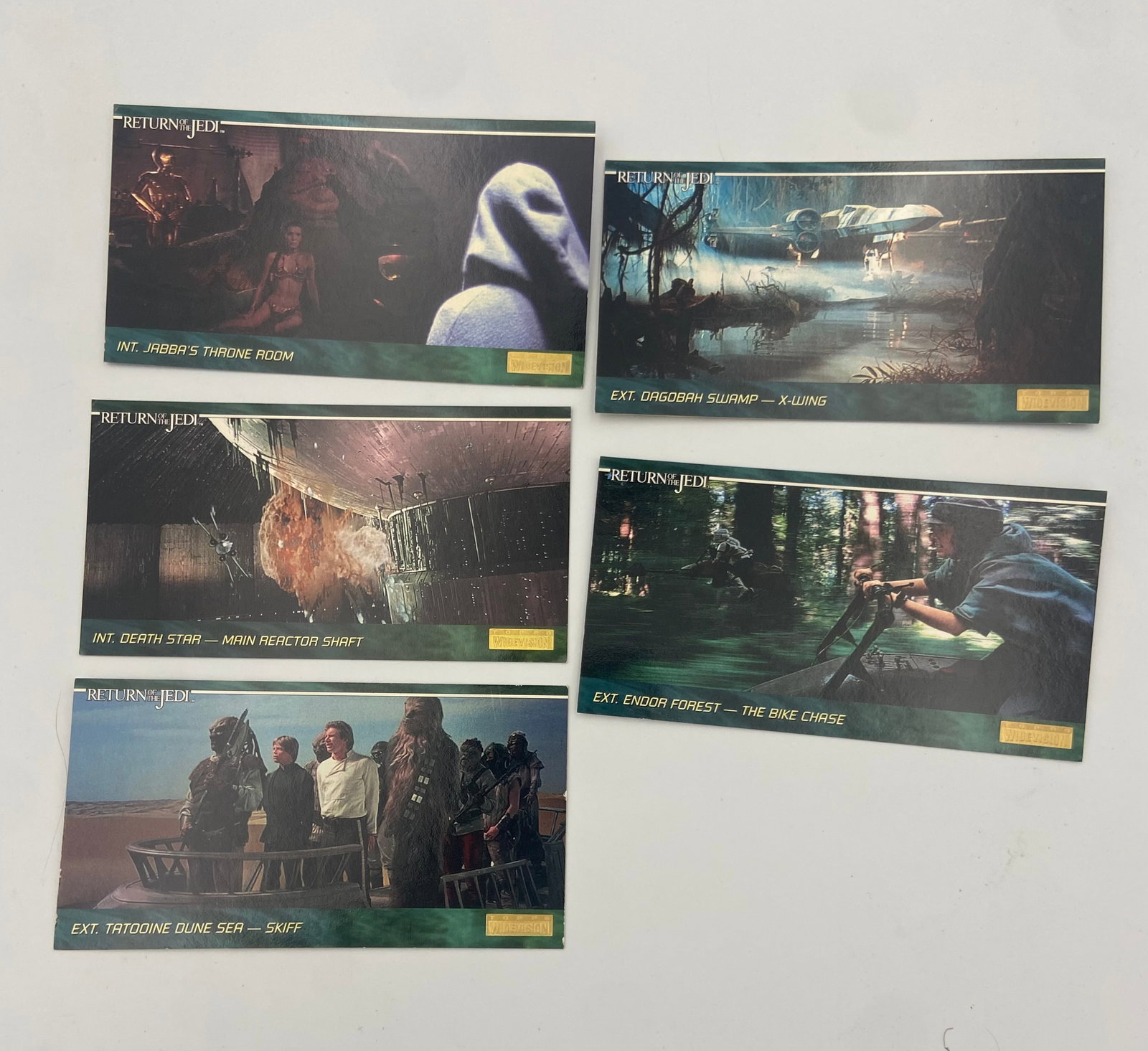 Topps Star Wars Return of the Jedi Widevision Trading Cards: A collection of five panoramic trading cards from the Star Wars Return of the Jedi Widevision set. These cards feature iconic scenes from the film, including Jabba's Throne Room, the Endor Forest