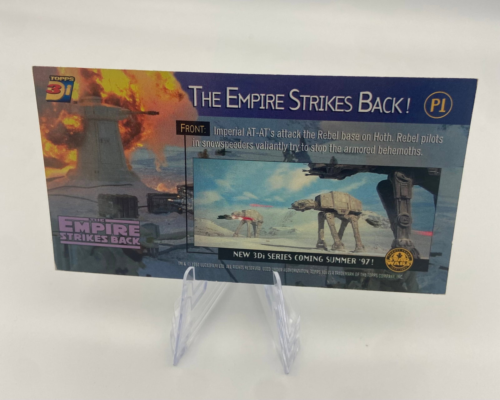 Topps Star Wars 3Di The Empire Strikes Back P1 Promo Card: vintage trading card featuring an AT-AT walker from the movie The Empire Strikes Back. The card showcases panoramic artwork of the battle on the ice planet Hoth. It represents a piece of classic Star 