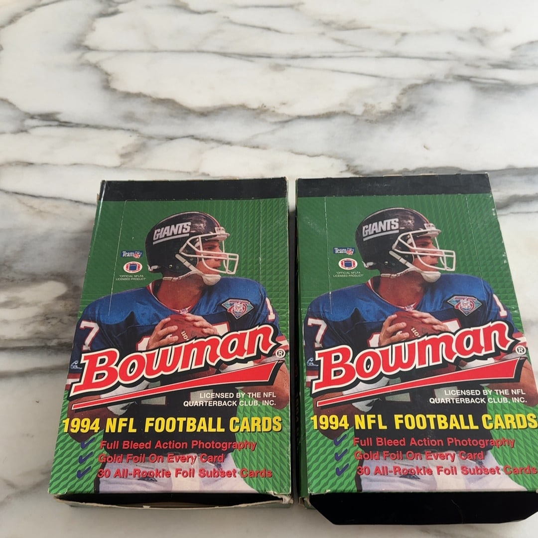 1994 Bowman Football Trading Card Boxes: These are two factory-sealed 1994 Bowman NFL football trading card boxes. The packaging highlights features such as full bleed action photography, gold foil on every card, and a subset of 30
