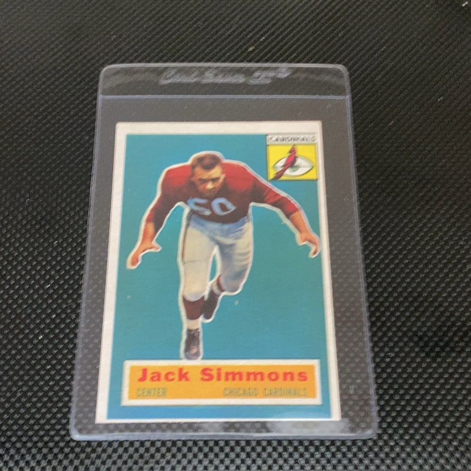 Jack Simmons Chicago Cardinals: This is a 1957 Topps football card featuring center Jack Simmons of the Chicago Cardinals. The vintage card remains in a protective Card Saver sleeve and displays the classic aesthetic of the 1957 Top