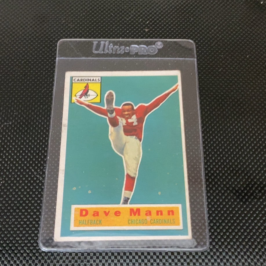 Vintage Dave Mann Chicago Cardinals Trading Card: This is a 1952 Bowman football card featuring Dave Mann of the Chicago Cardinals. The card showcases the iconic vibrant teal background and action illustration typical of this set. It is protected