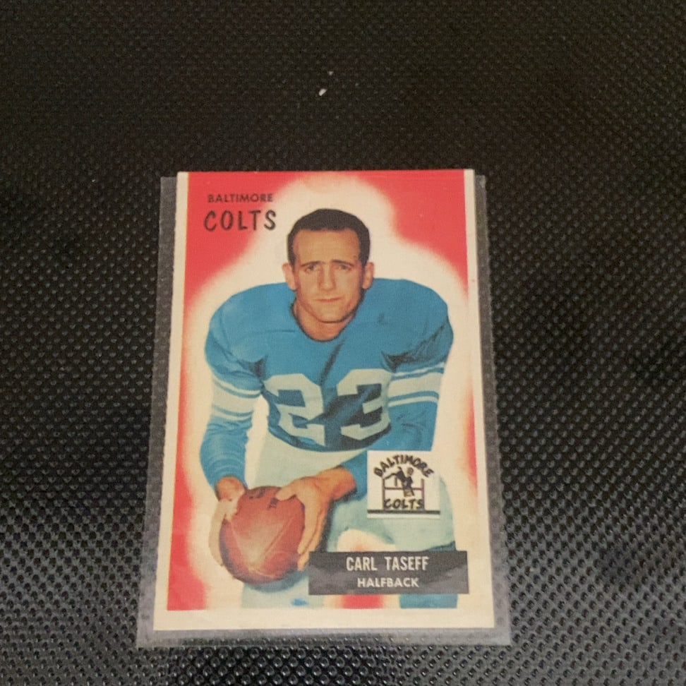 1958 Topps Carl Taseff: This is a 1958 Topps football card featuring Baltimore Colts halfback Carl Taseff. The card showcases a classic portrait illustration of the player wearing his blue uniform, along with a Baltimore Col